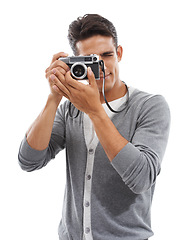 Image showing Photography artist, man and digital camera in studio for photoshoot, creative production or content creation on white background. Journalist, cameraman and photographer click lens for media magazine