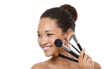 Image showing Makeup, brushes and happy woman in studio thinking of beauty, foundation and cosmetics. Face of young model, artist and person with skincare, application tools and product on a white background