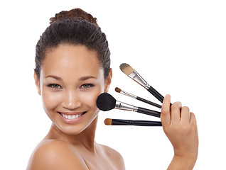 Image showing Makeup, brushes and portrait of happy woman in studio for beauty, foundation and cosmetics. Face of young model, artist and person with skincare, application tools and product on a white background