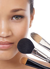 Image showing Makeup, brushes and portrait of young woman in studio for beauty, foundation and cosmetics. Face of a model, MUA artist and person with skincare, application tools and product on a white background