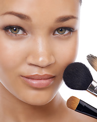 Image showing Cosmetics, brushes and portrait of young woman in studio for beauty, foundation and makeup. Closeup face of model, artist and person with skincare, application tools and product on a white background