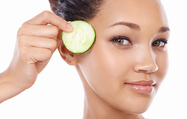 Image showing Skincare, cucumber and woman in portrait for beauty, cosmetics and natural product or Vitamin C makeup in studio. Face of a young model or person with green fruit or dermatology on a white background