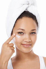 Image showing Young woman, face and beauty cream, skincare and cosmetics on a white background. Portrait of an African model or person with moisturizer application, skin care product and dermatology in studio