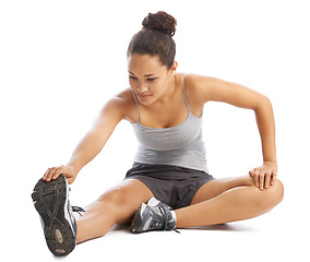 Image showing Woman, fitness and stretching legs in studio for workout, training and wellness a white background. Young person, athlete or runner in sneakers with muscle health, foot exercise and warm up on floor