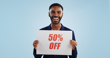 Image showing Excited man, portrait and sale sign for advertising, deal or discount against a blue studio background. Happy male person showing billboard or poster for marketing, promotion or special on mockup