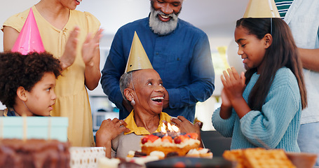 Image showing Cake, happy and family at birthday party celebration together at modern house with candles. Smile, excited and young children with African father and grandparents with hat for sweet dessert at home.