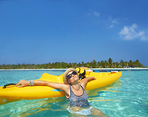 Image showing Woman, kayak and tropical sea in summer with sunglasses, mockup space and blue sky background by island. Person, boat or ship for transport, holiday or travel on vacation in sunshine, water or ocean