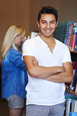 Image showing Portrait, arms crossed or happy man in a library for knowledge or development for future growth. Scholarship, education or male student with smile or pride for studying or learning in college campus