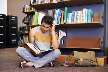 Image showing Reading book, floor or student in library at university, college or school campus for education growth. Bookshelf, learning or smart man with scholarship studying knowledge, research or information