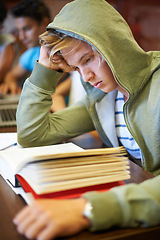 Image showing Classroom, students and high school boy with books, knowledge and studying for development at academy. Teenager, reading and learning process with thinking, scholarship and education for assessment