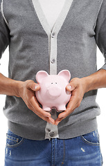 Image showing Person, hands or piggy bank in studio for investment, safety of finance or economy on white background. Closeup, financial savings or moneybox for investing income, funding or growth of future wealth