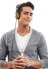 Image showing Music, man and headphones in studio for calm connection, audio subscription and streaming multimedia playlist on white background. Happy model listening to peaceful podcast, hearing sound and radio