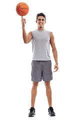 Image showing Man, portrait and basketball on finger for game, match or sports against a white studio background. Active male person or athlete smile with ball ready for fitness, skill or style on mockup space