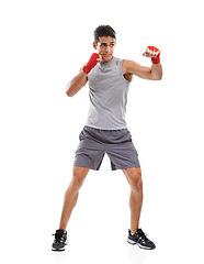 Image showing Boxer, man and kickboxing in studio with sports for fitness, health and martial arts isolated on white background. Strong athlete with muscle, action and fighting with MMA training and exercise