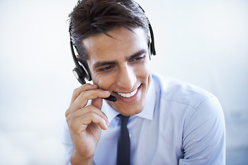 Image showing Call center, man and smile in studio for customer service, CRM questions and IT support on white background. Happy telemarketing salesman thinking of telecom advisory, microphone and contact for FAQ