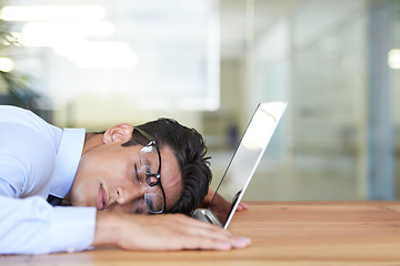 Image showing Business man, laptop and sleeping at desk, exhausted and burnout in office or dreaming in workplace. Male professional, nap and overtime or overworked, stress and fatigue or tired and deadline