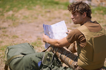 Image showing Soldier with map on battlefield, planning battle location or tactical operation goals for mission in war. Man is outdoor at military base camp, check strategy paperwork with army target and attack