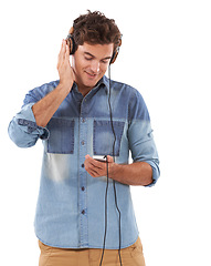 Image showing Technology, music and headphones with casual man in studio isolated on white background for streaming. Relax, smile or audio player with young guy listening to radio on sound device for entertainment