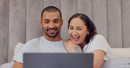 Image showing Laptop, happy and young couple in bed watching movie, film or show together at home. Smile, technology and man and woman relaxing in bedroom streaming a video on computer for bonding at modern house.