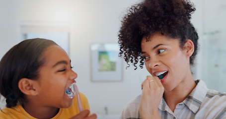 Image showing Hygiene, bathroom and mother brushing teeth with child for oral health and wellness at home. Bonding, happy and young mom and girl kid with morning dental care routine together at house in Mexico.