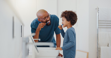 Image showing Hygiene, bathroom and father brushing teeth with child for oral health and wellness at home. Bonding, happy and young dad and boy kid with morning dental care routine together at house in Mexico.