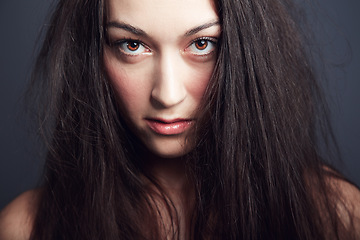 Image showing Woman, hair and beauty with confidence in portrait, cosmetic care in studio and long hairstyle on dark background. Empowered, fierce and edgy with young model and texture, growth and salon treatment