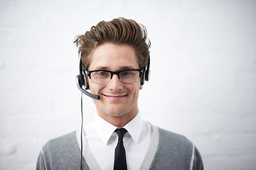 Image showing Business man, telemarketing and headphones in portrait, smile and microphone by wall background. Call center employee, worker or person with mic, pride and contact us with voip for technical support