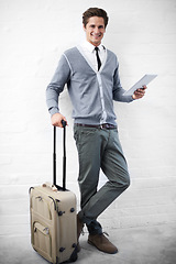 Image showing Business man, case or luggage with tablet, portrait and smile with app, flight or travel by wall background. Entrepreneur, person or employee with digital touchscreen, bag and happy for immigration