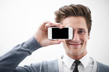 Image showing Business man, blank phone screen and portrait to cover eye with mockup space by white background. Entrepreneur, person or employee with smartphone, smile and presentation for promotion with mobile ux
