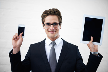 Image showing Business man, tablet and phone screen with smile, portrait and mock up space for promotion by wall background. Entrepreneur, person and happy employee with blank smartphone, touchscreen or ux for app
