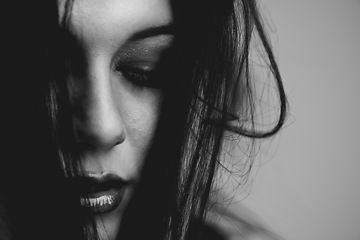 Image showing Woman, beauty and edgy makeup in studio, cosmetics and monochrome aesthetic by dark background. Female model person, face and skincare or haircare or goth, relaxing and serious attitude by backdrop