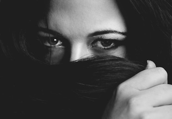 Image showing Woman, beauty and hiding by hair in portrait, cosmetics and monochrome aesthetic by dark background. Female model person, face and luxury shampoo or haircare in studio, mysterious and backdrop