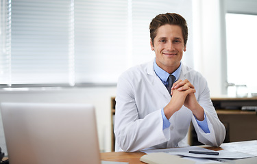 Image showing Smile, confident and portrait of doctor in his office for consultation with laptop and positive attitude. Happy, technology and professional young male healthcare worker at desk in medical clinic.