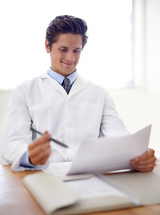 Image showing Happy, document and portrait of man doctor in the office for consultation in a medical hospital. Smile, reading and professional young male healthcare worker with paperwork for research in a clinic.