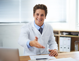 Image showing Handshake, happy and man doctor in office for greeting hello at a medical consultation at clinic. Smile, professional and young male healthcare worker with shaking hand gesture in a medicare hospital