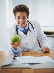 Image showing Happy, apple and portrait of man doctor with stethoscope for positive, good and confident attitude. Smile, pride and young male healthcare worker with fruit in medical office of hospital or clinic.