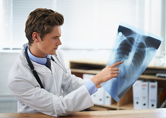 Image showing Man doctor in office, analysis of xray and health, medical diagnosis and review of lung scan at cardiology clinic. Radiology, assessment of results and human anatomy with surgeon, MRI and skeleton