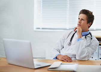 Image showing Laptop, thinking and man doctor in his office for consultation with brainstorming for diagnosis treatment. Ideas, computer and professional young male healthcare worker with decision face at hospital