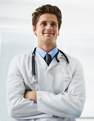 Image showing Happy, crossed arms and portrait of man doctor with stethoscope for positive, good and confident attitude. Smile, pride and young male healthcare worker in medical office of hospital or clinic.