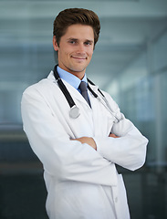 Image showing Confident, crossed arms and portrait of man doctor with stethoscope for positive, good and confident attitude. Happy, pride and young male healthcare worker in medical office of hospital or clinic.