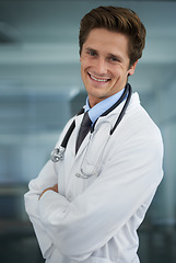 Image showing Smile, crossed arms and portrait of man doctor with stethoscope for positive, good and confident attitude. Happy, pride and young male healthcare worker in medical office of hospital or clinic.