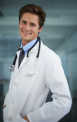 Image showing Smile, pride and portrait of man doctor with stethoscope for positive, good and confident attitude. Happy, career and professional young male healthcare worker in medical office of hospital or clinic