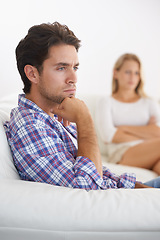 Image showing Man, angry and living room couch with disagreement, upset and thinking with anger, fight or mad. Divorce, betrayal and relationship with cheating, stress and argument for marriage, home and woman