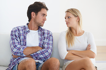 Image showing Couple, angry and living room couch with disagreement, upset and staring with anger, fight or mad. Divorce, betrayal and relationship with cheating, stress and argument for marriage, home or toxic