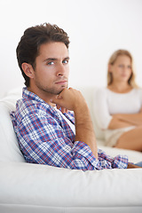 Image showing Man, angry and living room couch with disagreement, upset and thinking with anger, fight or mad. Divorce, betrayal and relationship with cheating, stress and argument for marriage, home and woman