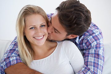 Image showing Happy couple, portrait and kissing with hug, marriage and embrace for love, home and couch. Wife, husband and smile for commitment, bonding together and care for relationship, man and woman