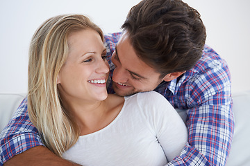 Image showing Happy couple, smile and romance with hug, marriage and embrace for love, home and couch. Wife, husband and house for commitment, bonding together and soulmate for relationship, man and woman