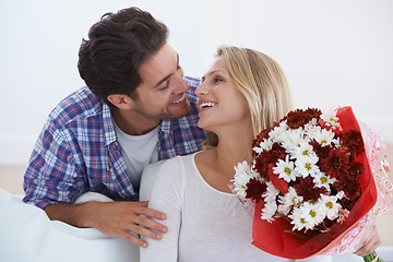 Image showing Man, flowers and surprise in home, happy woman and hug boyfriend for anniversary celebration. Birthday gift, romance and bouquet for love, present and valentines day with romantic gesture and smile