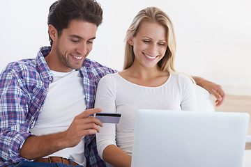 Image showing Happy couple, laptop and credit card for online shopping, payment or banking together in relax at home. Man and woman smile with debit on computer for ecommerce, transaction or fintech at house