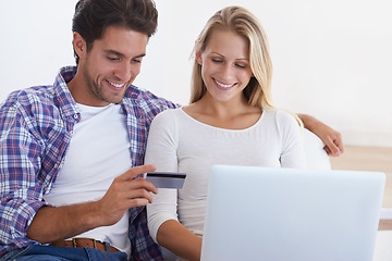 Image showing Happy couple, laptop and credit card for ecommerce, payment or banking together in relax at home. Man and woman smile with debit on computer for online shopping, transaction or fintech at house